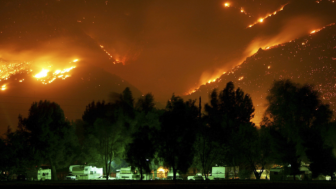 photo of Esperanza Fire burns near trailers before dawn on October 27, 2006 in Banning, California, west of Palm Springs