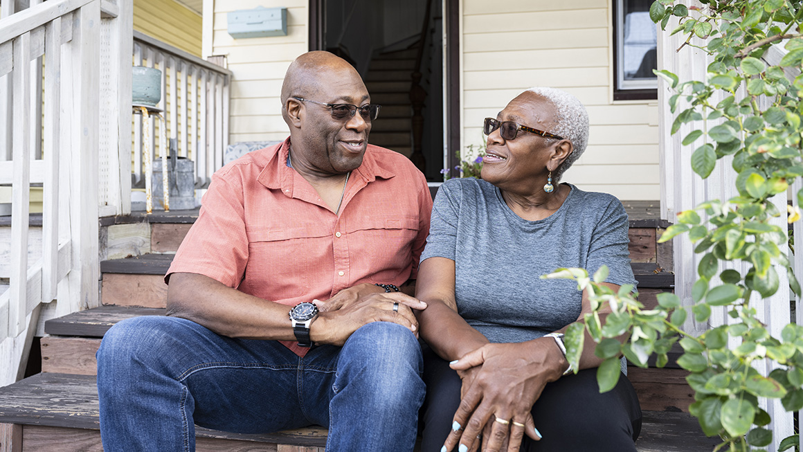 photo of relaxed senior Black couple sitting on front steps