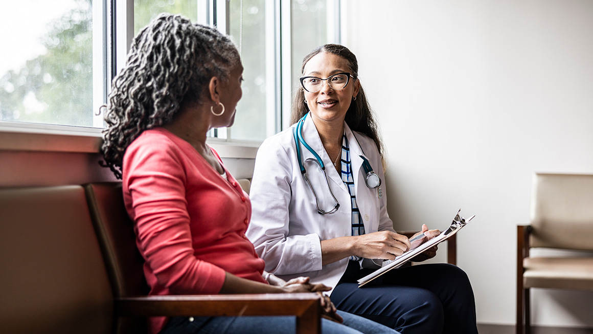 A woman sitting down with her doctor.