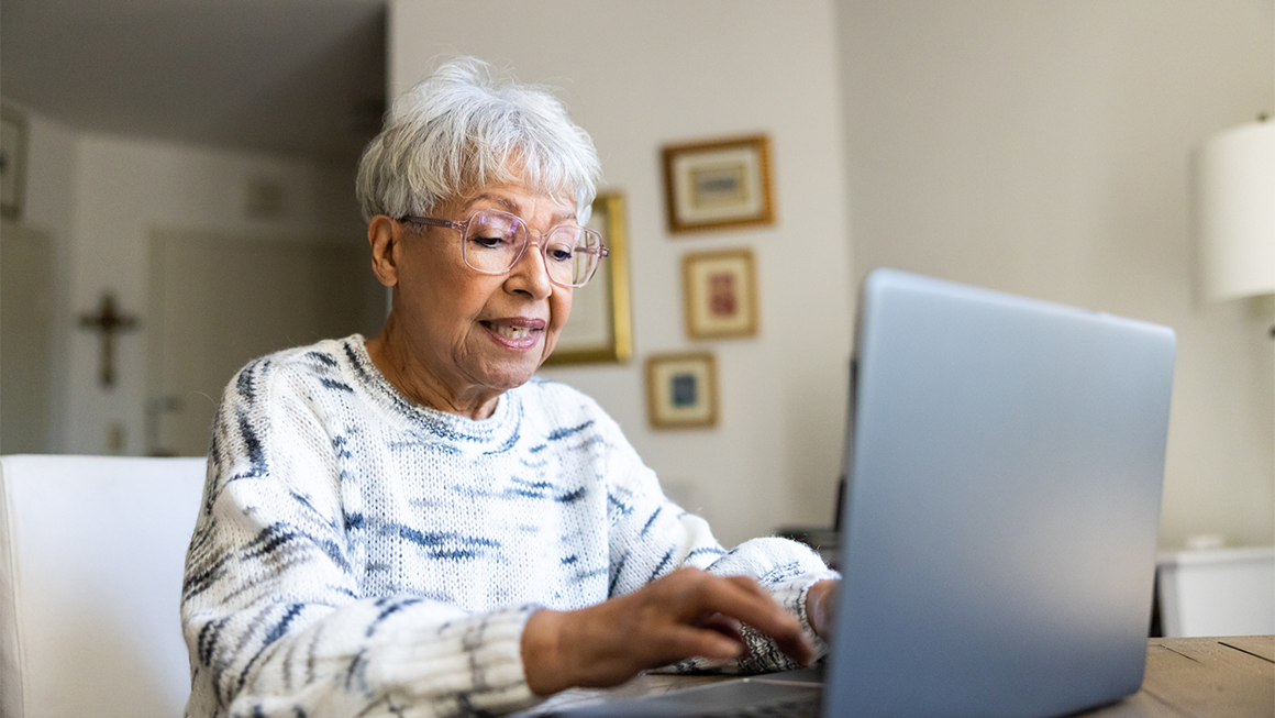 photo of woman using a laptop computer at home
