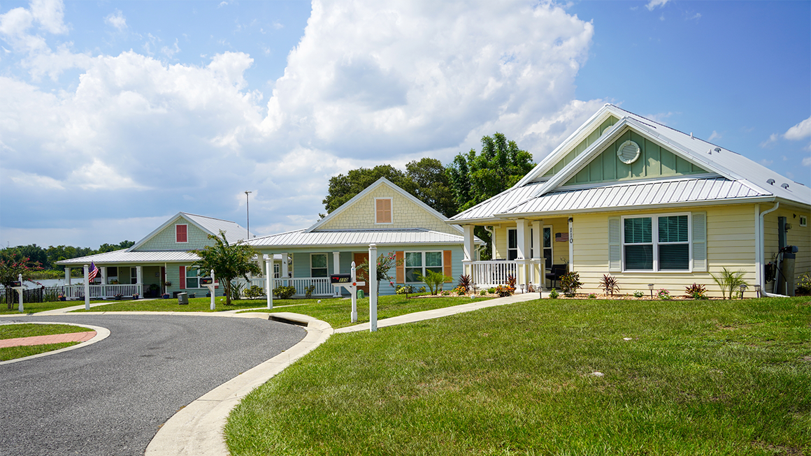 Image of three single family houses with large, lush yards