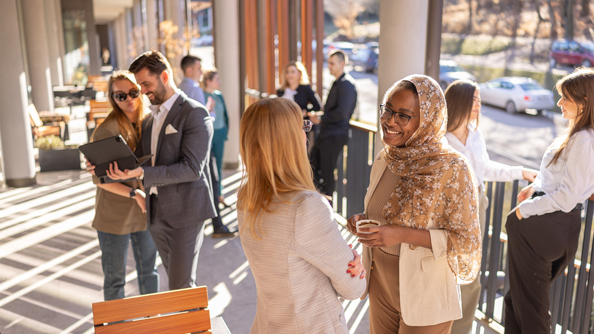 Two women chat at a professional convening.