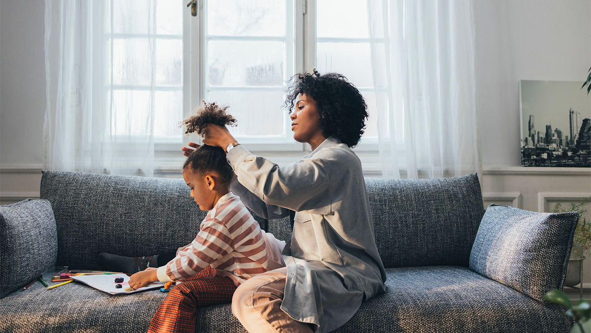 Mother doing her daughter's hair.