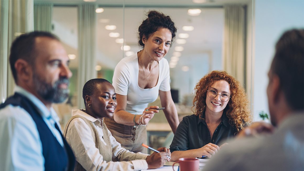 A group of professionals working together in a conference room. 