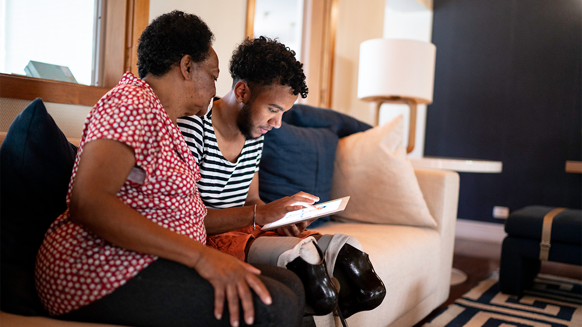 A mother and son sitting on a couch. 