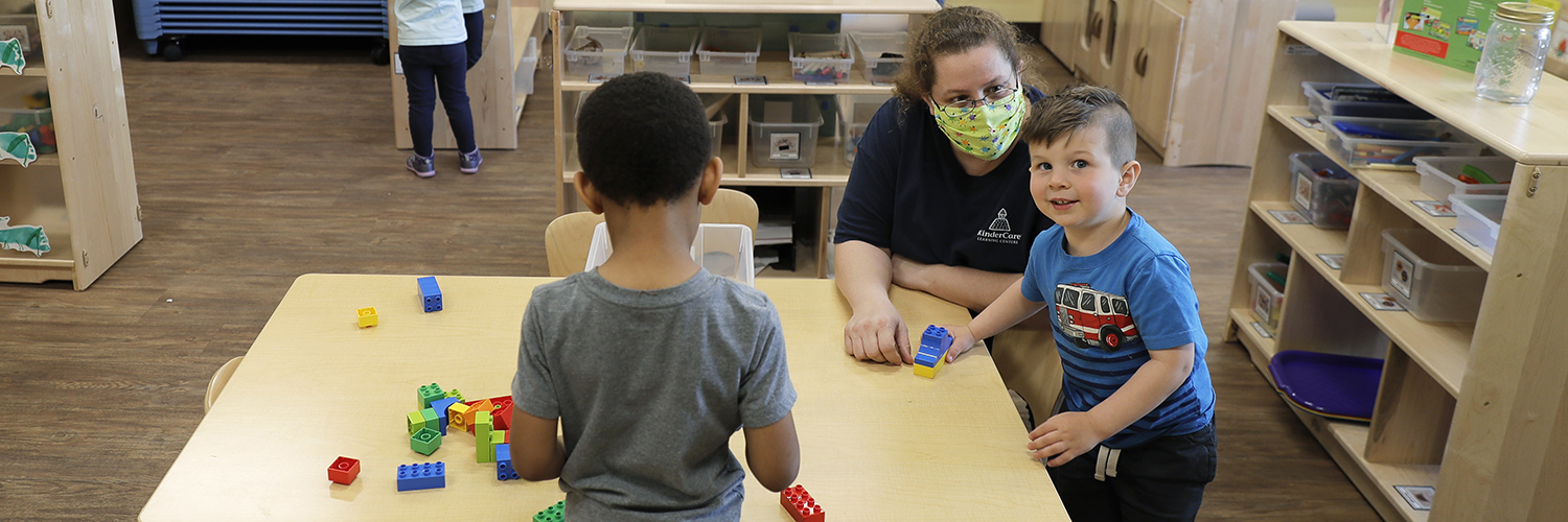 Daycare teacher plays with kids during COVID-19