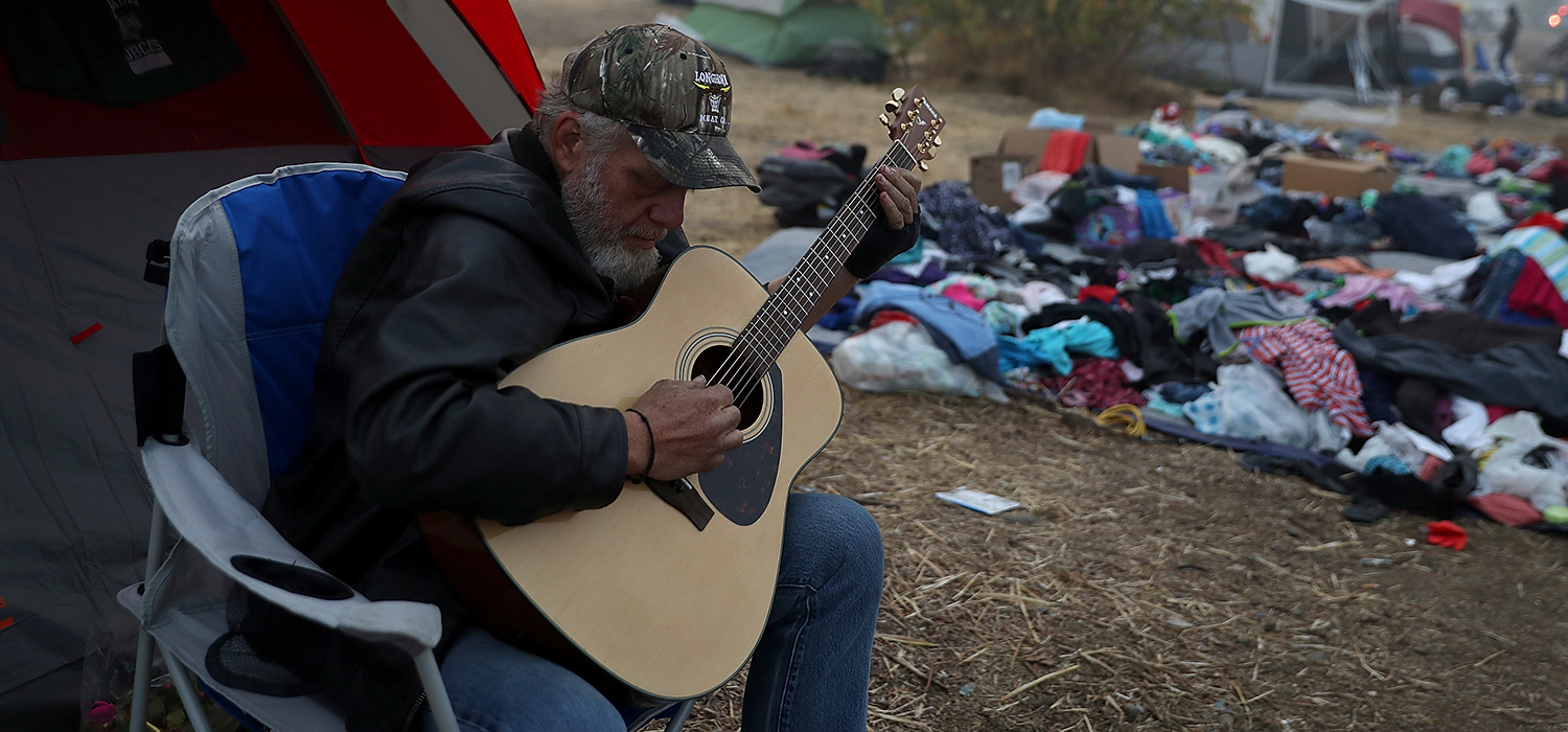 Man who was displaced during Camp Fire plays guitar