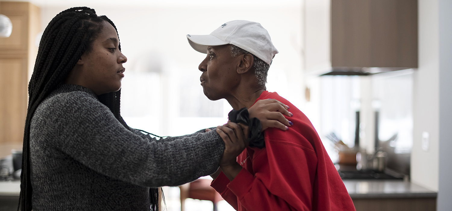 Women helps her mother who has Alzheimer's disease