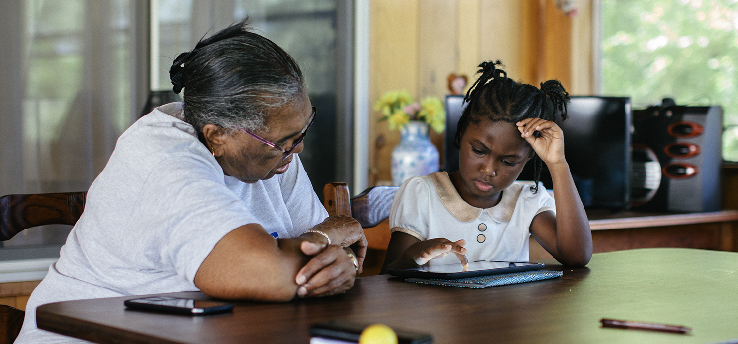 Caretaker helps child with remote learning