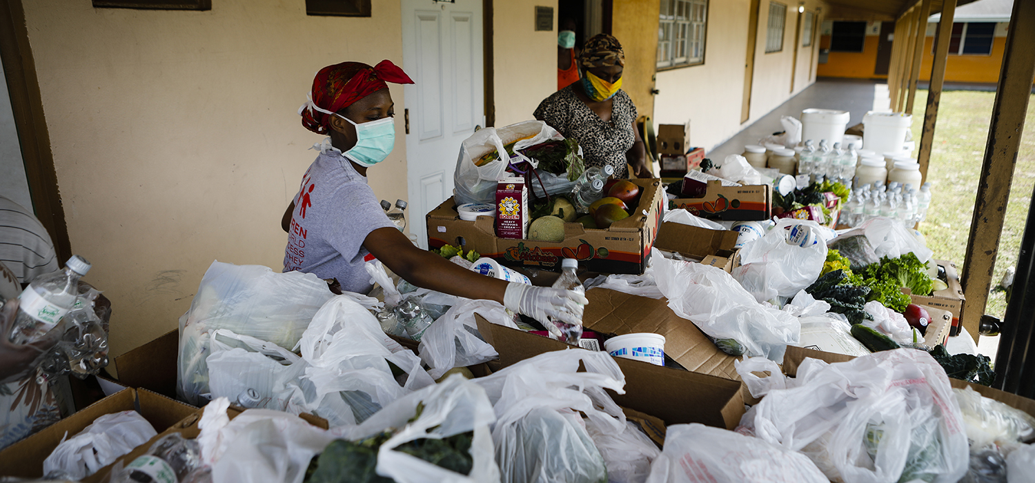 Volunteers pack groceries during the COVID-19 pandemic