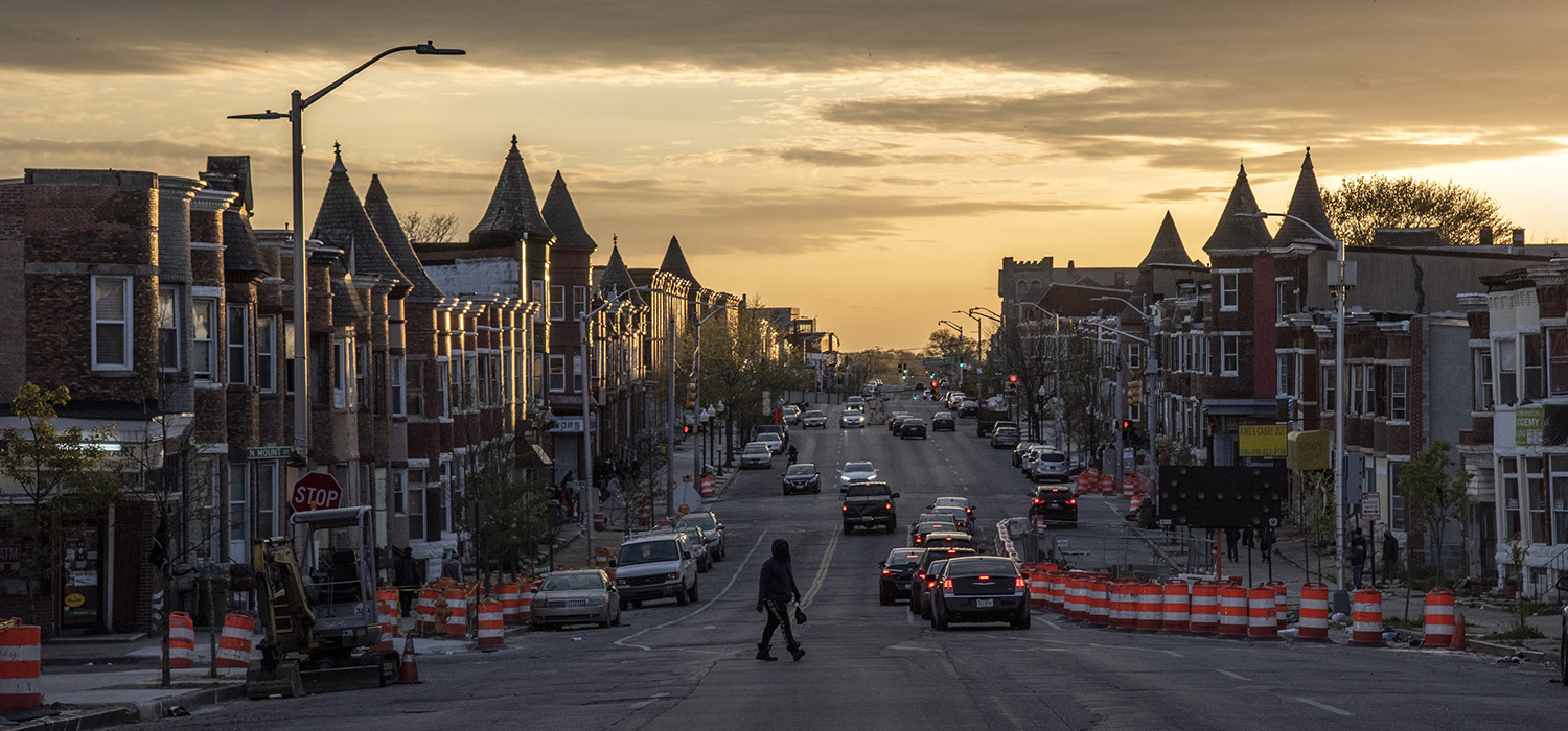 The sun sets over  W. North Avenue in Baltimore, Maryland