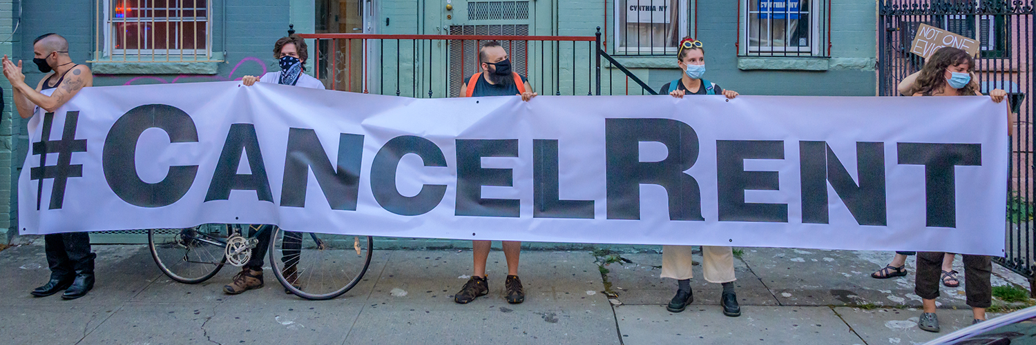 Protesters hold "cancel rent" sign
