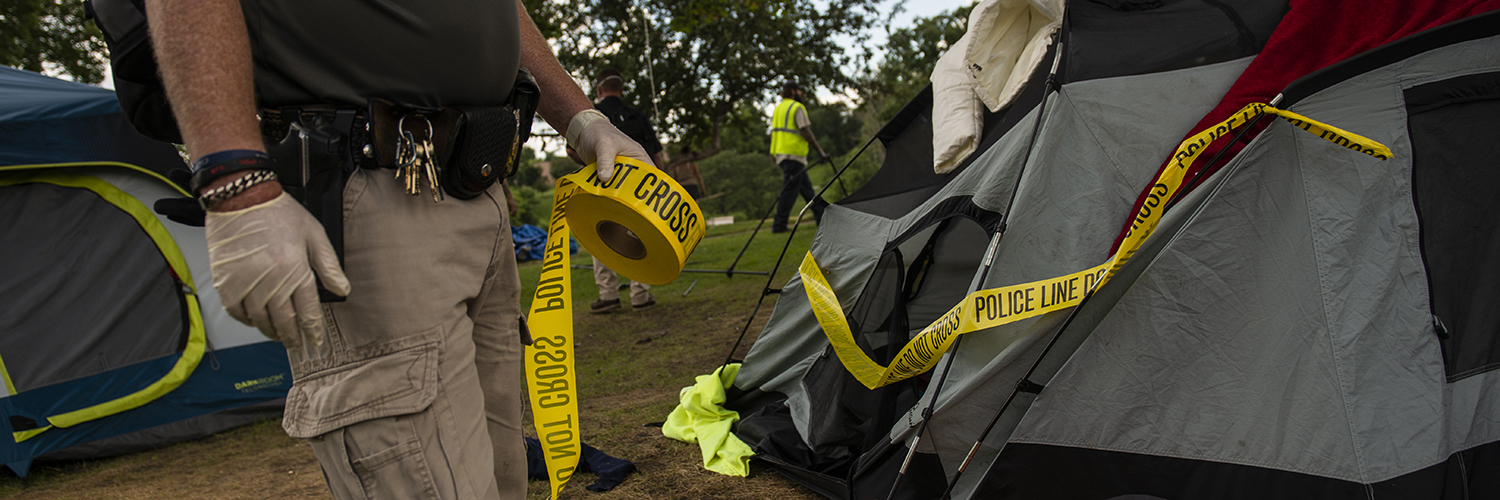 Police marks tent for removal at a homeless encampment