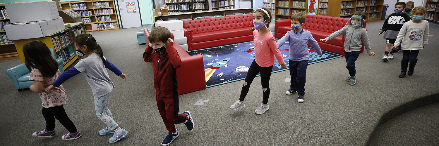 Kindergarten students practice social distance walking through the library at Lupine Hill Elementary School in Calabasas, CA