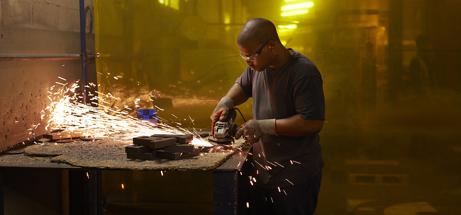 Apprentice uses power tools