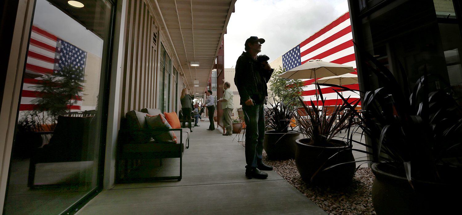 Veteran experiencing homelessness stands with his dog