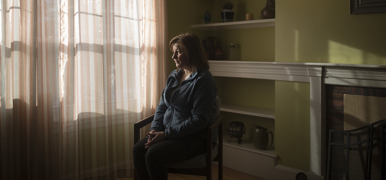 Woman sits in her house