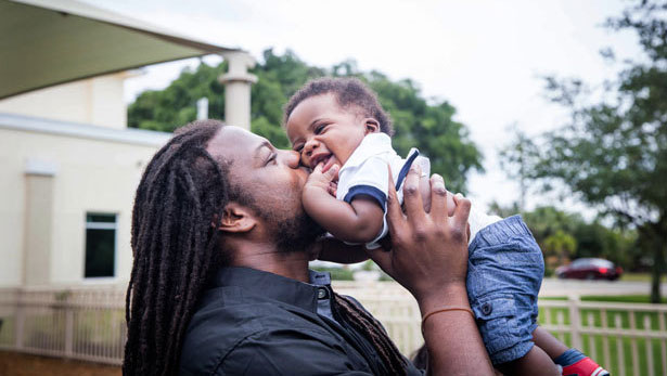 black man kissing baby