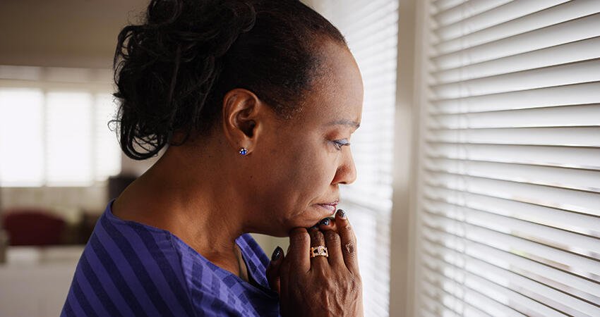 Woman looks out window