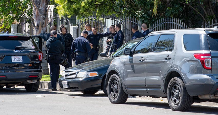 Police gather in a neighborhood