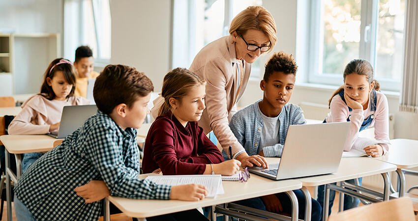 Children at school working on a laptop together