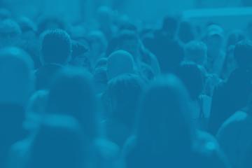 Crowd of people talking through a city.