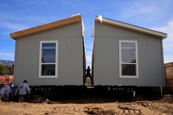 Workers constructing a manufactured home.