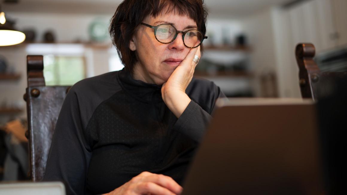 photo of person looking at laptop