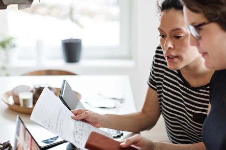 Two people review paperwork together