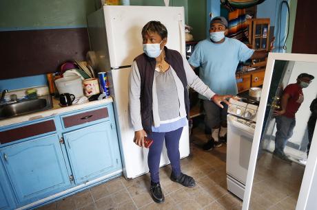 Maria Martinez with her son Ricardo Martinez, right, talk to Roberto Garcia-Ceballos, reflected in the doorway, at the Tokio Hotel on Monday, Oct. 4, 2021. 