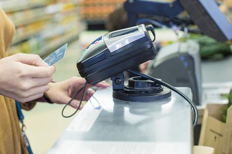 Women paying at grocery store