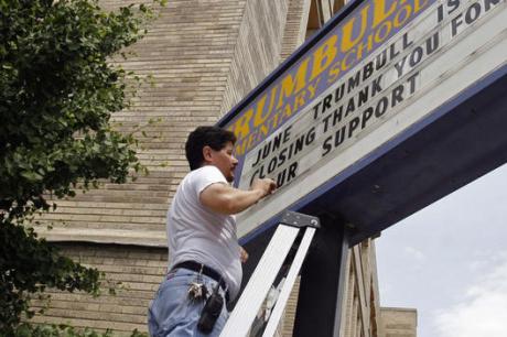Man changing school sign