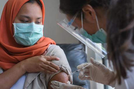 Woman getting a vaccine. 