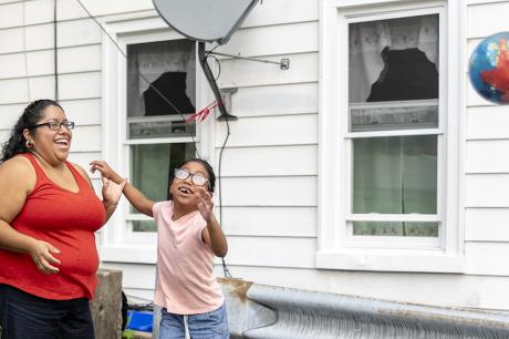 A parent and child play outside