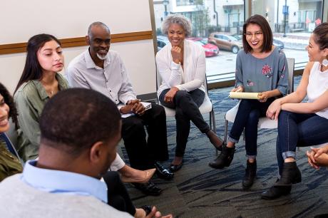 A group of people sitting around a circle.