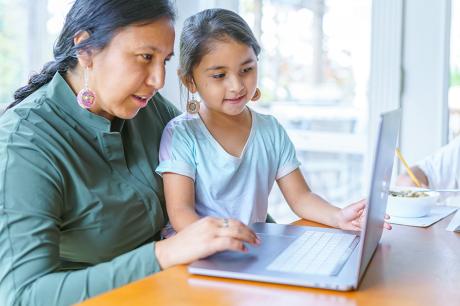 Woman and daughter looking at a laptop