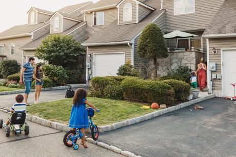 Young family outside a house.