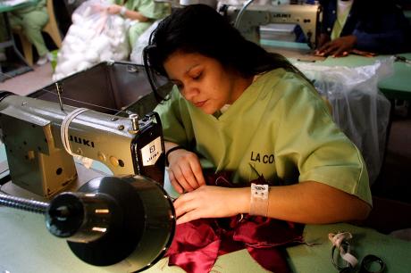 nmate Priscilla Sandoval, 26, sews doll clothing for dolls that will be distrbuted to needy children for Christmas at Twin Towers jail.