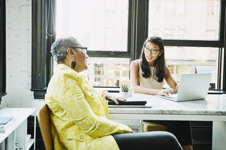 Two women talking at a table