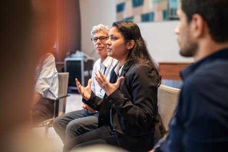 Woman speaking among a group of people