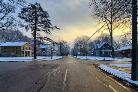 A photo of snowy residential street. 