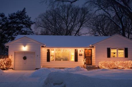 an Image of a house with snow surrounding. 