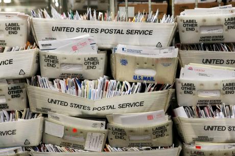 stacks of us postal mail. 
