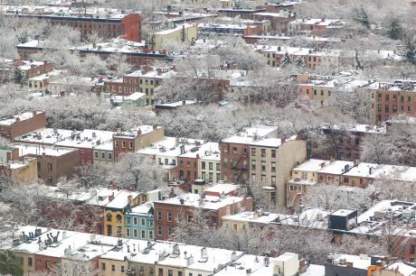 An aerial image of housing with snow on the ground.