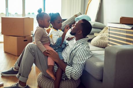 A father and his daughters in their new home.