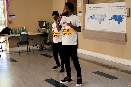 Two Forward Justice speakers giving a presentation