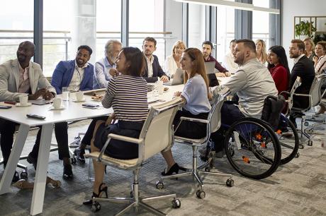 A group of people at a large meeting desk.