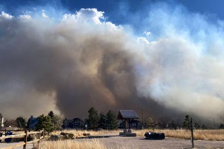Smoke from the Marshall Fire in Louisville, CO can be see in a large smoke plume as it covers the horizon