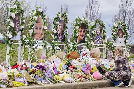 A woman looks on at the memorial for the Covenant School shooting victims at the Covenant School. 