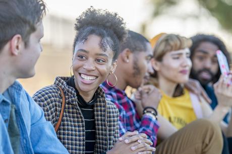 A group of young adults spending time together outside. 